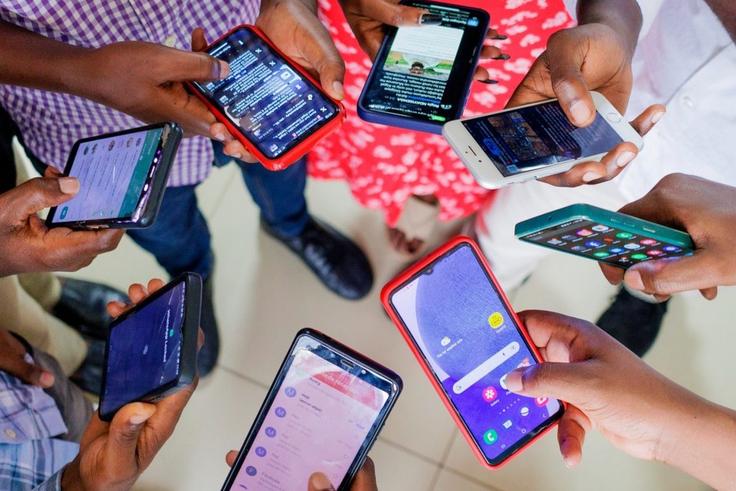 A group of people using mobile phones
