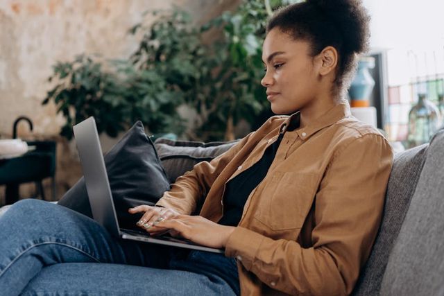 A person focussed on their laptop [Image Credit: Mikhail Nilov]