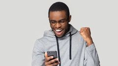 An excited man using a phone