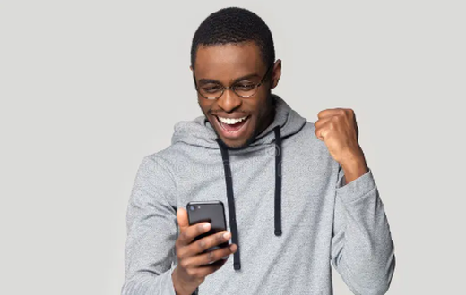 An excited man using a phone
