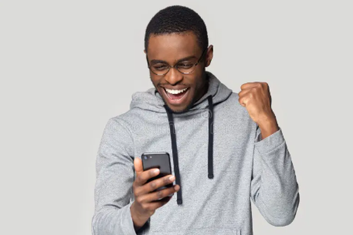An excited man using a phone