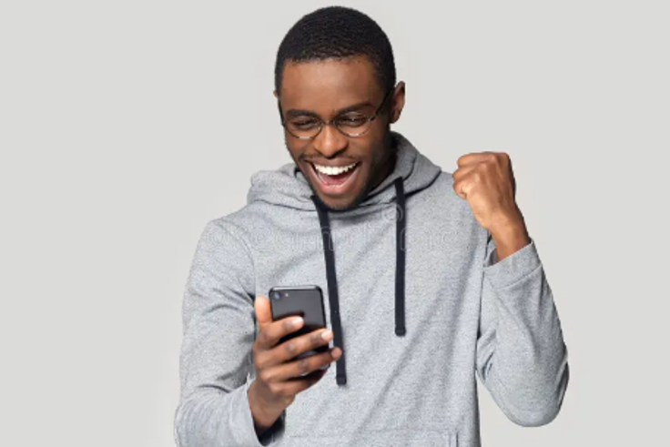 An excited man using a phone