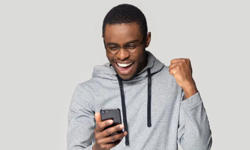 An excited man using a phone