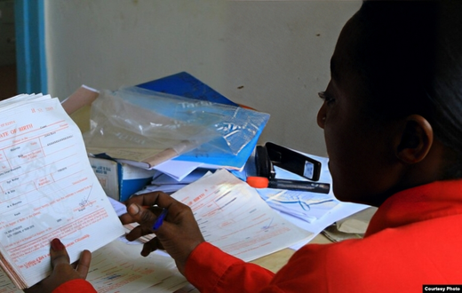 A government officer issues birth certificates