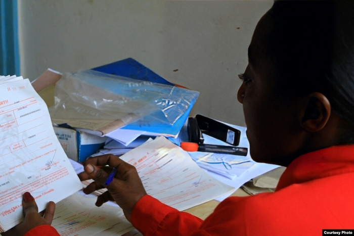 A government officer issues birth certificates