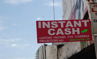File image of a signage directing clients to an entity offering loans on items
