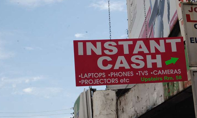 File image of a signage directing clients to an entity offering loans on items