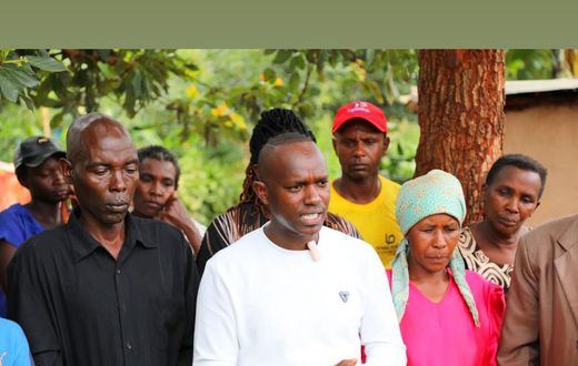 Gukena FM's MC Kajim when he visited the family of David Gitau in Gatundu