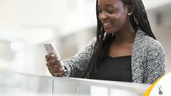 A lady using her phone to buy Kenya Power tokens