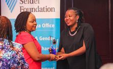 Lynn Ngugi accepting an award