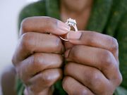 A woman holding a ring