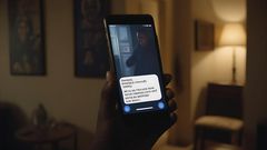 An AI generated image of a phone in a dimly lit room showing text messages