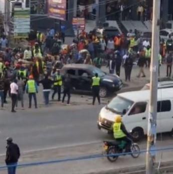 Boda boda riders and pedestrians at the scene in Kitengela where the car was stoned on Thursday