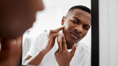 Photo of man looking himself on the mirror