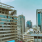 An AI-generated image of urban landscape in Nairobi, Kenya featuring modern high-rise buildings with visible air conditioning vents The scene depicts a clear sky and bustling