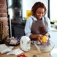 A photo of a woman using a stand mixer in the kitchen