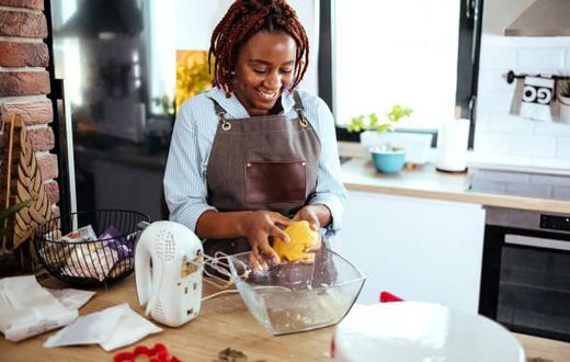 A photo of a woman using a stand mixer in the kitchen