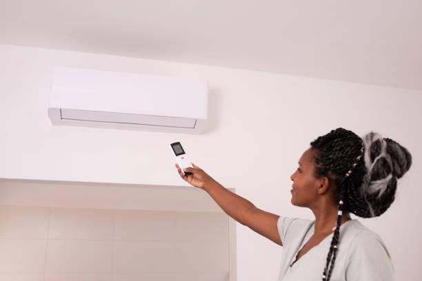 A woman operating an air conditioning system