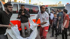 The body of a victim killed in an Israeli bombardment is taken out of an ambulance in Gaza City.DAWOOD NEMER/AFP via Getty Images