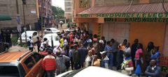 A crowd outside the building where a woman was found dead in an apartment reported to be an airbnb in Roysambu