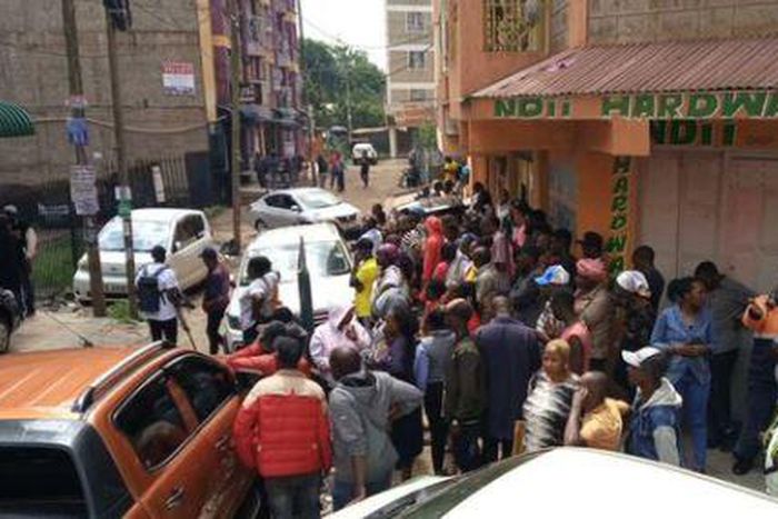A crowd outside the building where a woman was found dead in an apartment reported to be an airbnb in Roysambu