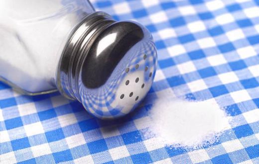 Close up of a pile of salt on a table cloth