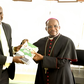 PS Julius Bitok hands over copies of Digital ID FAQ booklet to Kenya Conference of Catholic Bishops chairman Archbishop Martin Kivuva