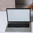 A person using Macbook Pro on white table [Photo: Cottonbro Studio]