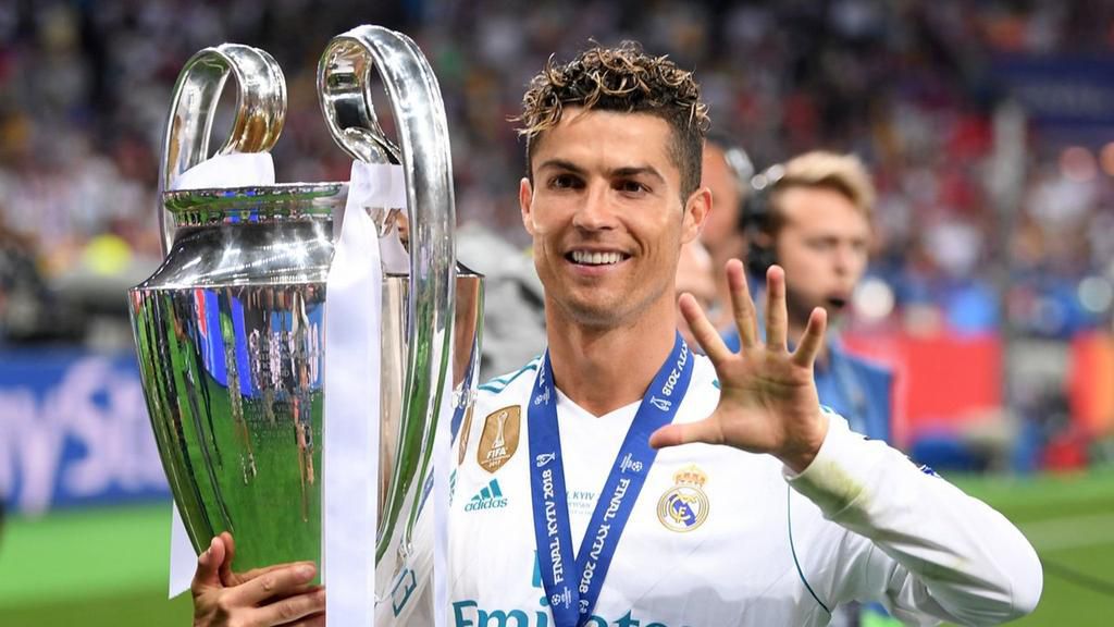 Cristiano Ronaldo posing with the Champions League title and gesturing that he has won it five times.