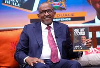 Defence CS Aden Duale takes a photo with his book, 'For The Record'