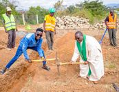 MCA Tricky a priest and workers during the launch of construction of the house.in September 2022
