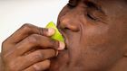 Close-up of a man biting into a lemon half