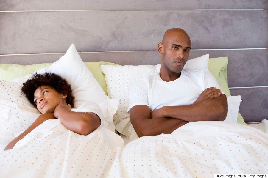 Sad couple in bed