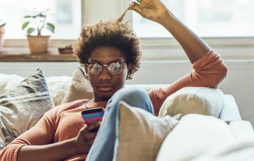 Young woman using smart phone at home