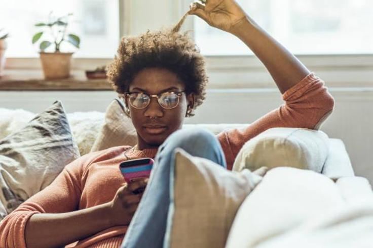 Young woman using smart phone at home