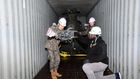 South Korean and US military personnel inspect a 500MD helicopter loaded on a container It is one of six retired helicopters to be donated to Kenya for UN peacekeeping missions