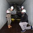 South Korean and US military personnel inspect a 500MD helicopter loaded on a container It is one of six retired helicopters to be donated to Kenya for UN peacekeeping missions