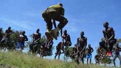 A KDF official takes recruits through a drill during tryouts