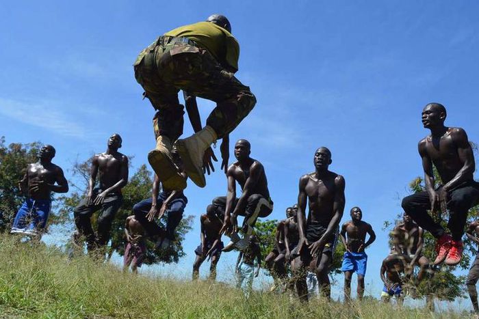 A KDF official takes recruits through a drill during tryouts