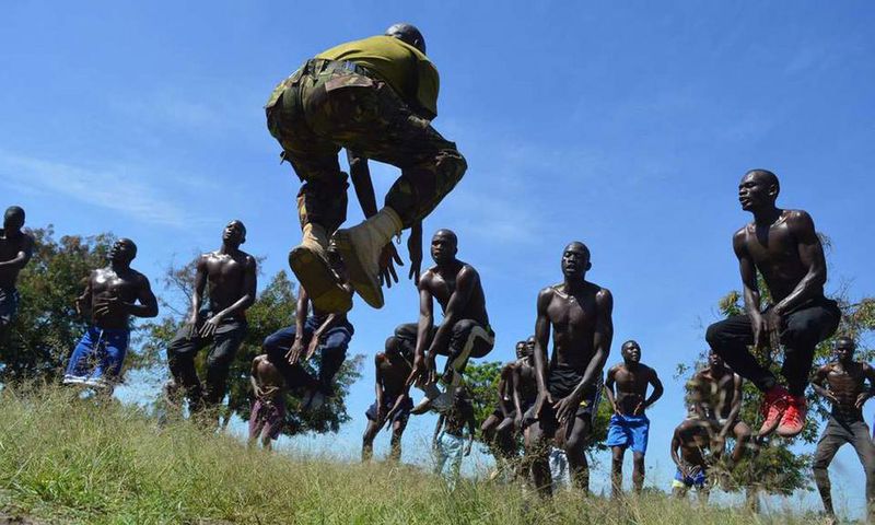 A KDF official takes recruits through a drill during tryouts