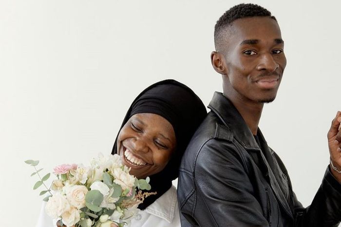 Beautiful couple smiling while standing together [Image: Darina Belonogova]