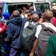 Students scrambling to board a matatu