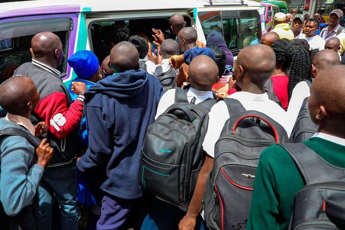 Students scrambling to board a matatu