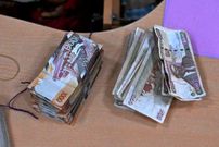 This picture taken on September 30, 2019 shows old and new-issue currency bills on a desk at a branch of a local bank in the Kenyan capital, Nairobi. (Photo by TONY KARUMBA/AFP via Getty Images)
