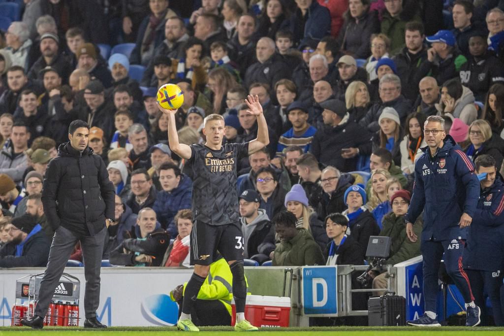Arsenal defender Oleksandr Zinchenko (35) ready for a throw in either side of Arsenal Manager Mikel Arteta & Assistant Manager Albert Stuivenberg during the Premier League match between Brighton and Hove Albion and Arsenal on December 31, 2022.