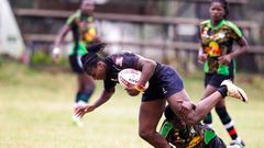 Mwamba's Terry Ayesa (centre) and Janet Okello (left) charge past Top Fry Nakuru Ann Akinyi during the Kenya Cup Women league match played at Impala Club on November 27, 2021. Photo/CHRIS OMOLLO