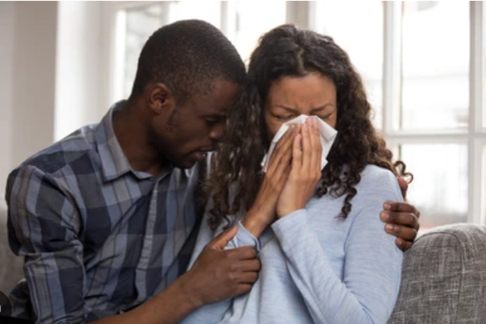 File photo: Man consoles weeping woman (Source: Shutterstock)