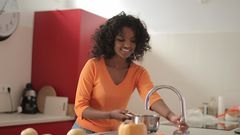 A lady using the kitchen