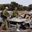 Israel soldiers inspect burnt cars at the site of the Hamas terrorist attacks on the Nova music festival in southern Israel.Amir Cohen/Reuters