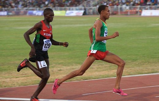 Kenyan Gilbert Kwemoi (Left) and Ethiopian Bekele Ayele Demoz run during the 12th African Juniors Athletics Championships in Addis Ababa, Ethiopia, on March 6, 2015. (Photo by Orhan Karsli/Anadolu Agency/Getty Images)
